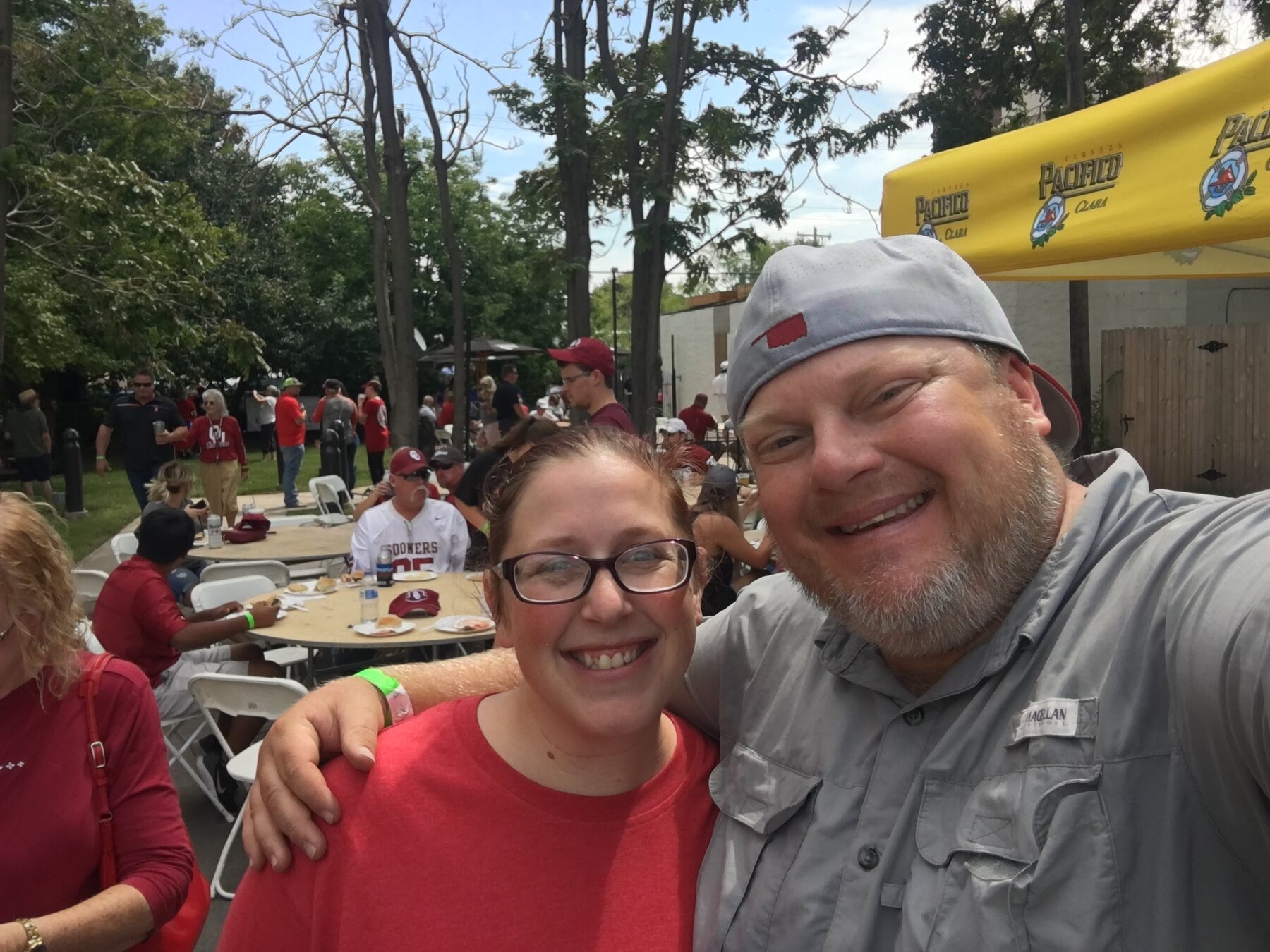 Matt Hill and a guest smiling together with an Oilfield Tailgate crowd behind them at Othello’s in 2017