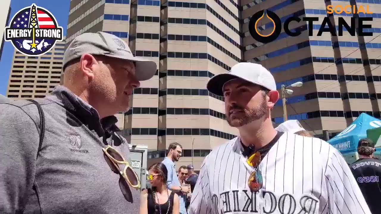 Oilfield Tailgate host talking with an energy professional at an outdoor industry party